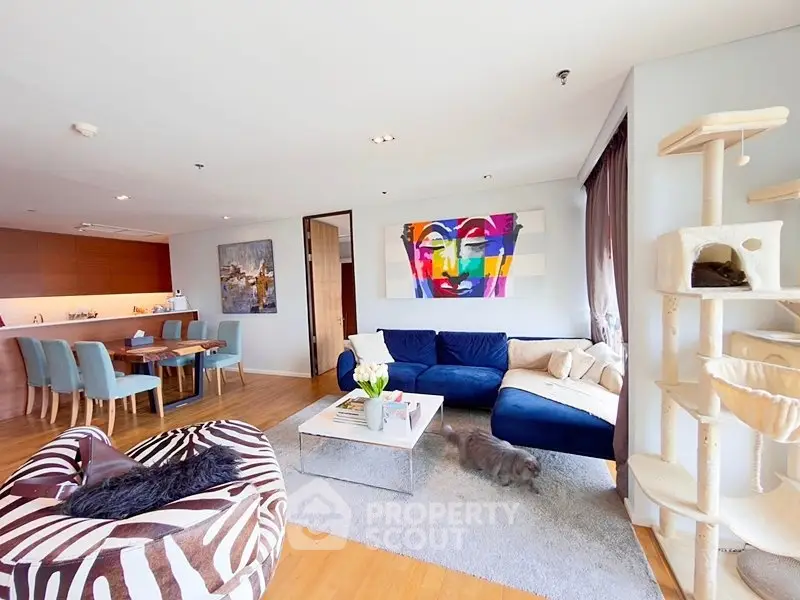 Spacious modern living room with vibrant art and cozy seating