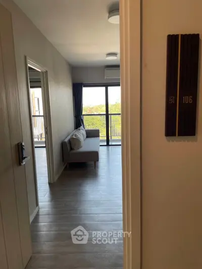 Modern apartment entrance with sleek flooring and balcony view