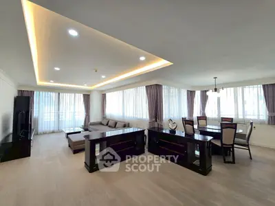 Spacious modern living room with elegant dining area and large windows