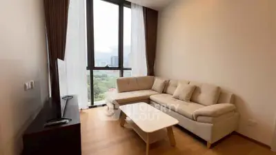 Modern living room with large windows and cozy sectional sofa