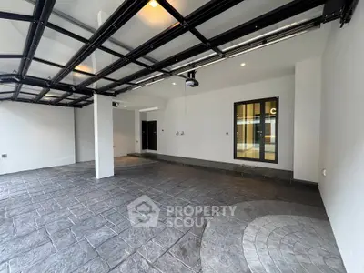 Spacious modern garage with sleek design and ample lighting, perfect for luxury vehicles.