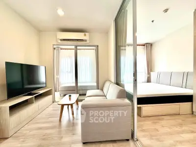 Modern living room with sleek furniture and natural light in a stylish apartment.