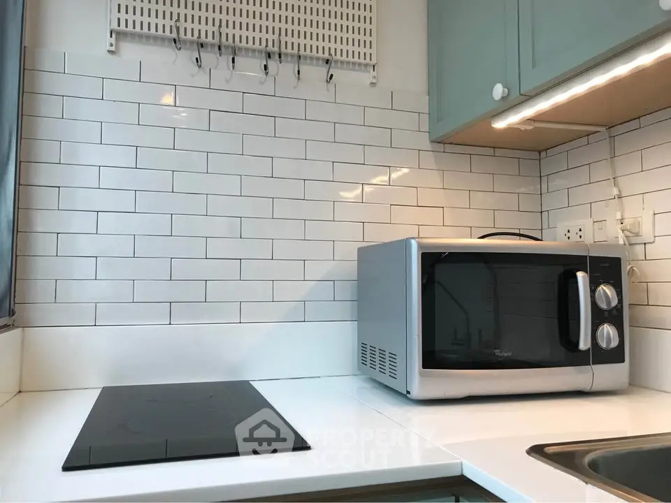 Modern kitchen with sleek appliances and subway tile backsplash