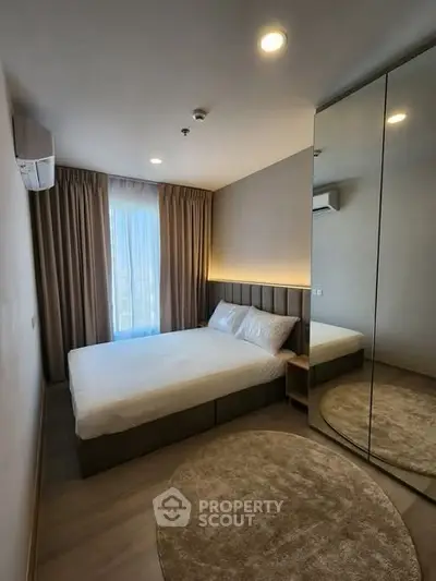 Modern bedroom with mirrored wardrobe and cozy lighting