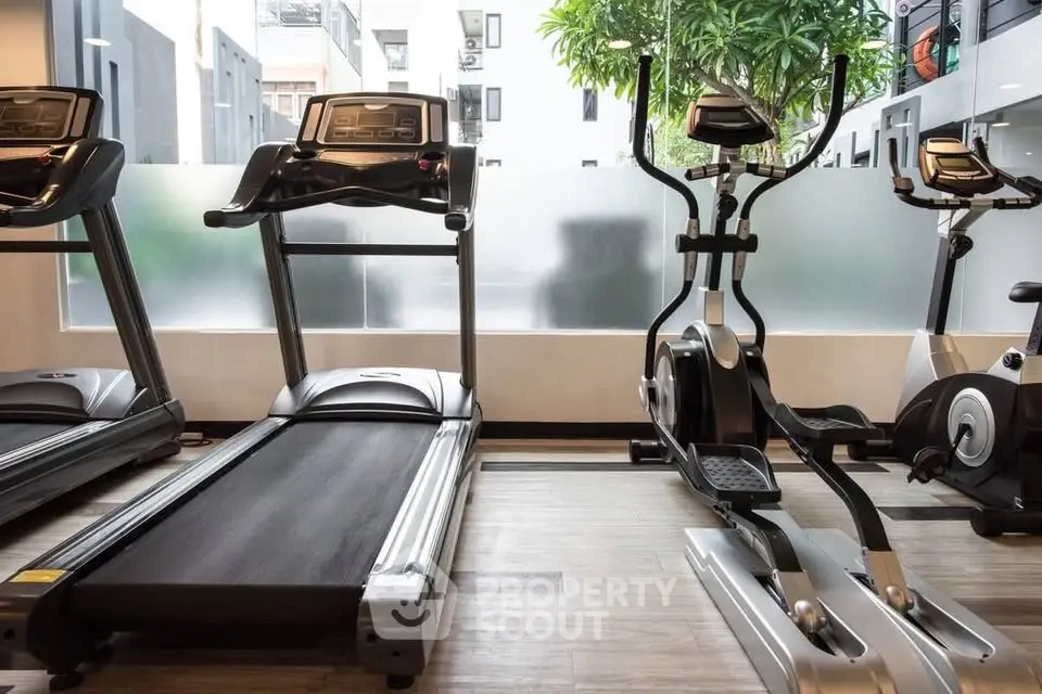 Modern gym with state-of-the-art equipment in a luxury residential building.