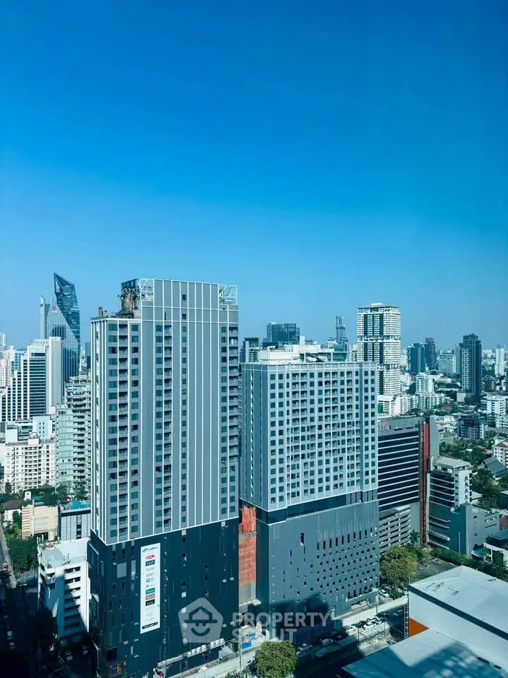 Stunning cityscape view showcasing modern high-rise buildings under a clear blue sky.