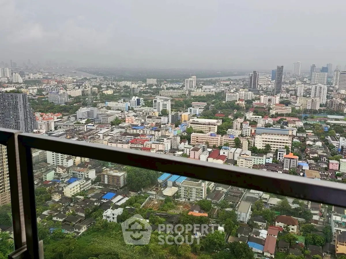Stunning cityscape view from high-rise balcony overlooking urban skyline.