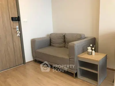Cozy living room corner with modern gray sofa and stylish side table.