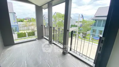 Spacious balcony with modern railing and scenic neighborhood view