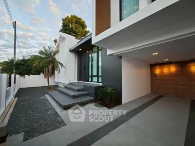 Modern house exterior with sleek design and spacious driveway