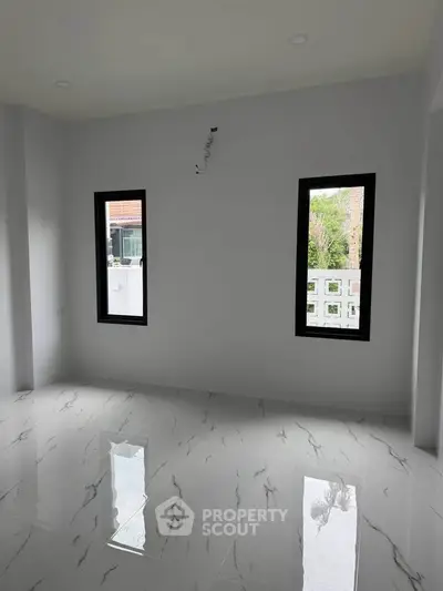 Spacious unfurnished room with glossy marble flooring and large windows for natural light.
