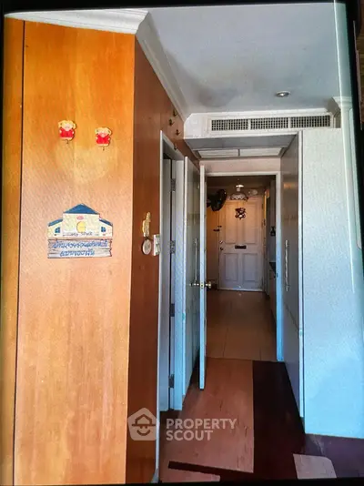 Cozy apartment hallway with wooden accents and decorative elements.