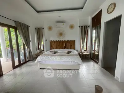 Spacious bedroom with natural light and elegant decor