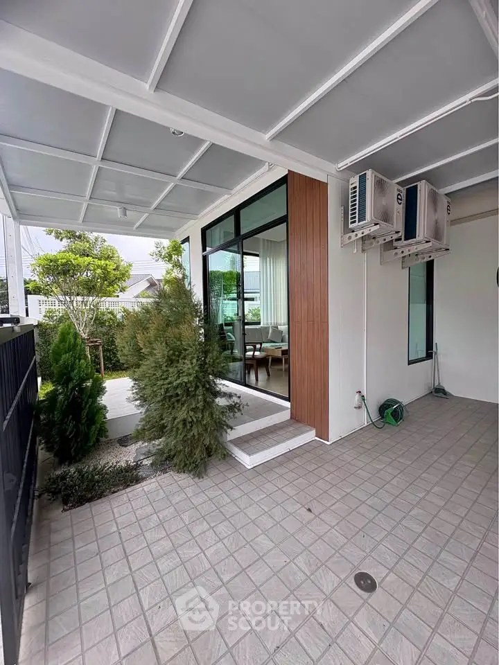 Modern home exterior with covered patio and garden view
