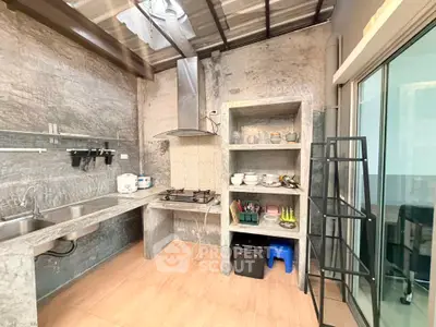 Modern industrial-style kitchen with open shelving and gas stove