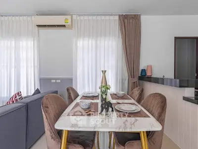 Stylish dining area with elegant table setting and cozy living room in modern apartment