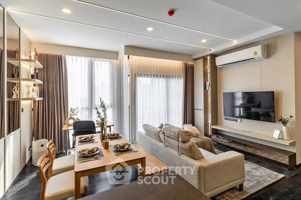 Modern living room with stylish decor, large windows, and cozy seating area in a contemporary apartment.