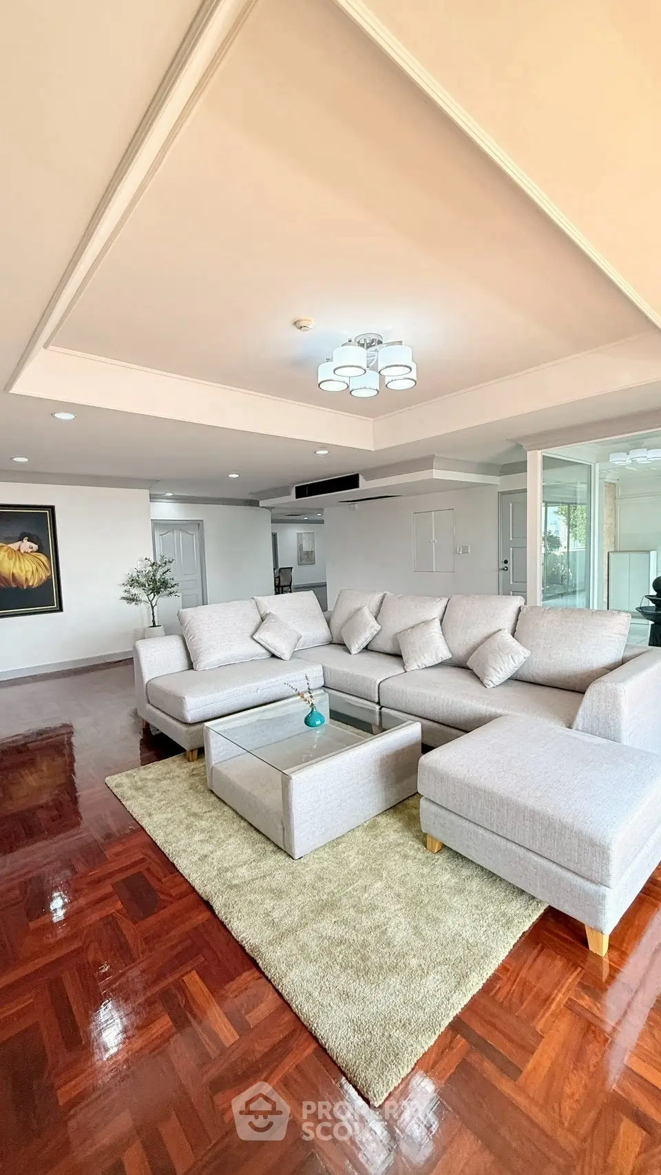 Spacious living room with modern sectional sofa and elegant hardwood flooring