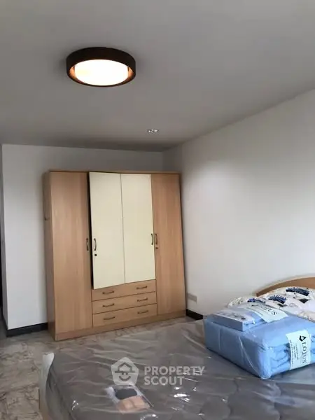 Spacious bedroom with modern wardrobe and cozy lighting