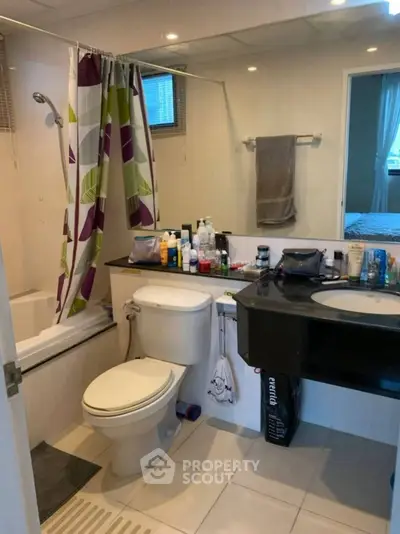 Modern bathroom with sleek fixtures and colorful shower curtain
