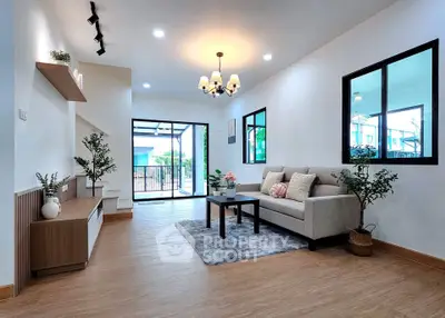 Spacious modern living room with elegant decor and large windows for natural light.