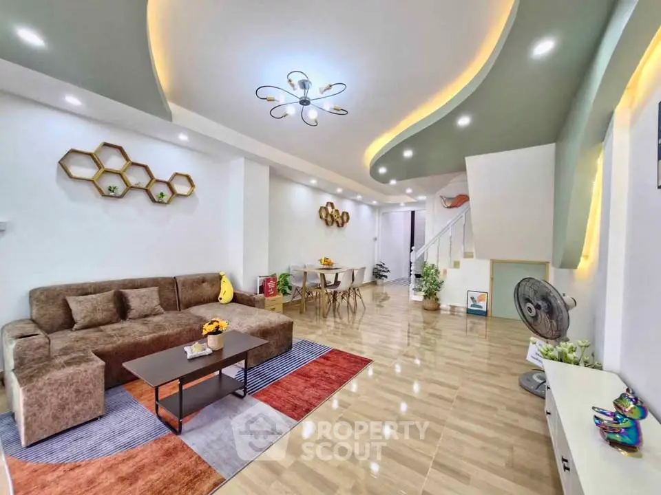 Spacious modern living room with stylish decor and unique ceiling design