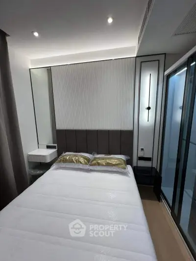 Modern bedroom with sleek design and elegant lighting in a contemporary apartment.