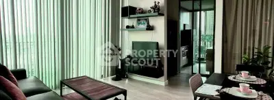 Modern living room with floor-to-ceiling windows and stylish decor in a high-rise apartment.