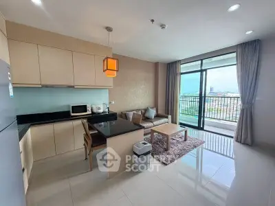 Modern open-layout kitchen and living room with balcony view in a stylish apartment.