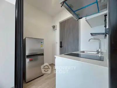 Modern compact kitchen with sleek appliances and minimalist design