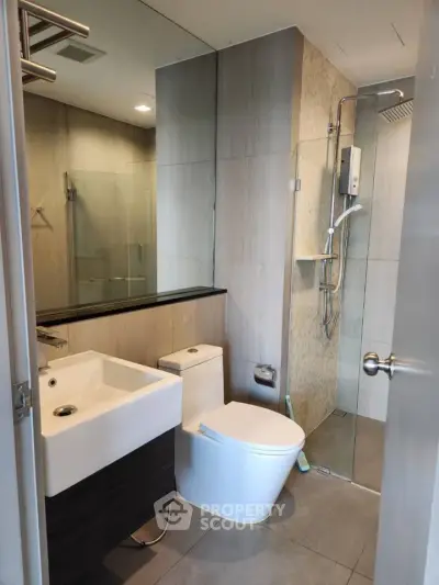 Modern bathroom with sleek fixtures and glass shower enclosure