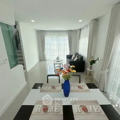 Bright and spacious living room with modern decor and large windows