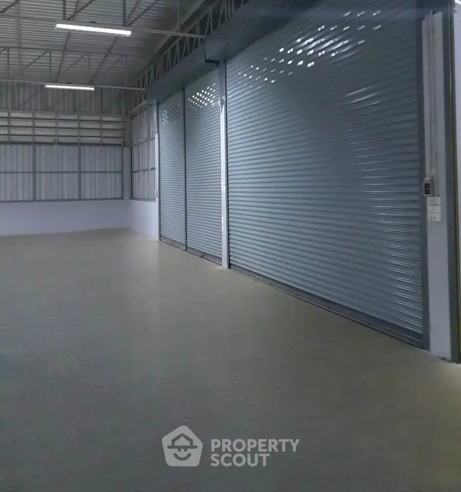 Spacious industrial warehouse with large roller doors and high ceilings