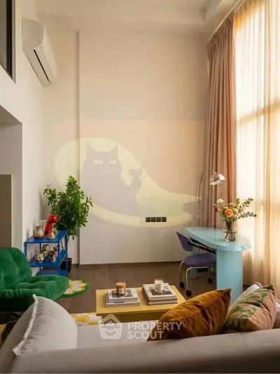 Stylish living room with modern decor, large window, and cozy seating area.