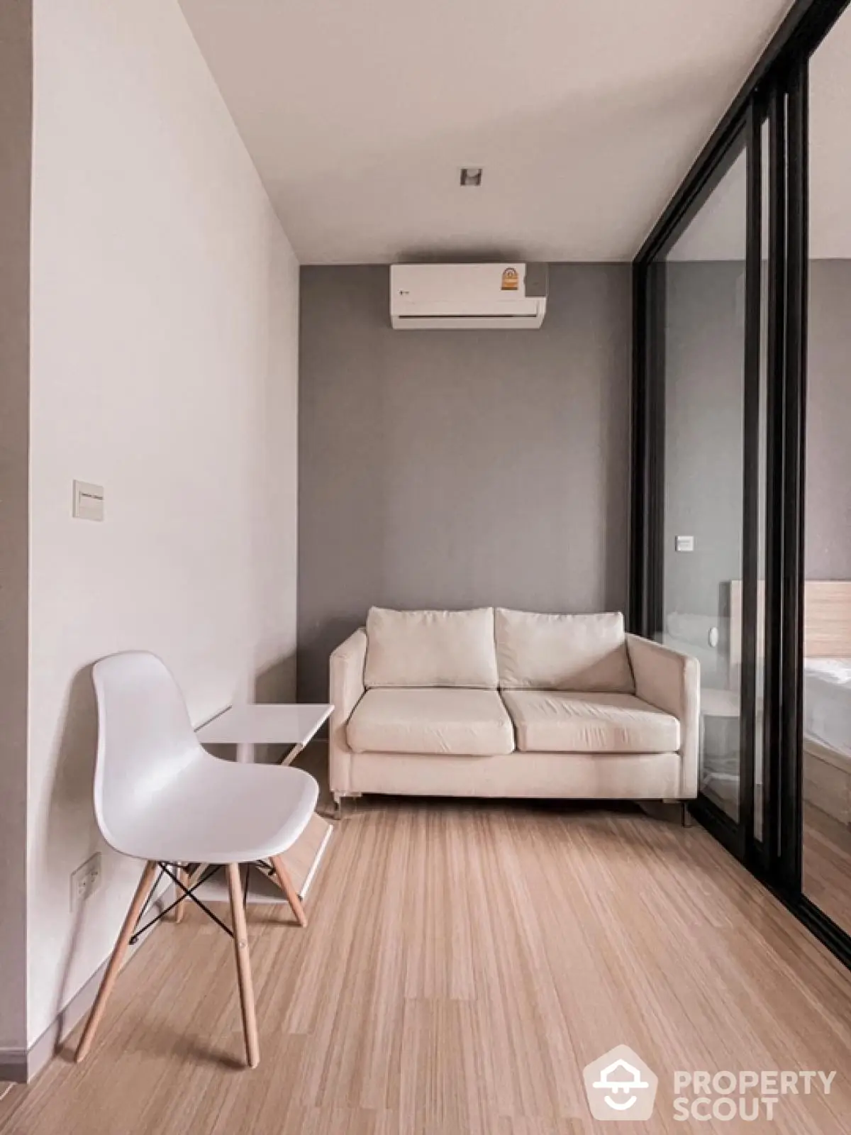 Modern minimalist living room with white sofa and sleek wooden flooring