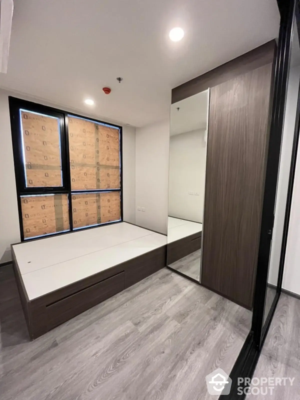 Modern bedroom with large mirror and built-in storage bed