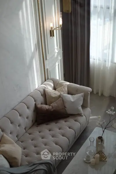 Elegant living room with plush sofa and soft lighting, perfect for relaxation and comfort.