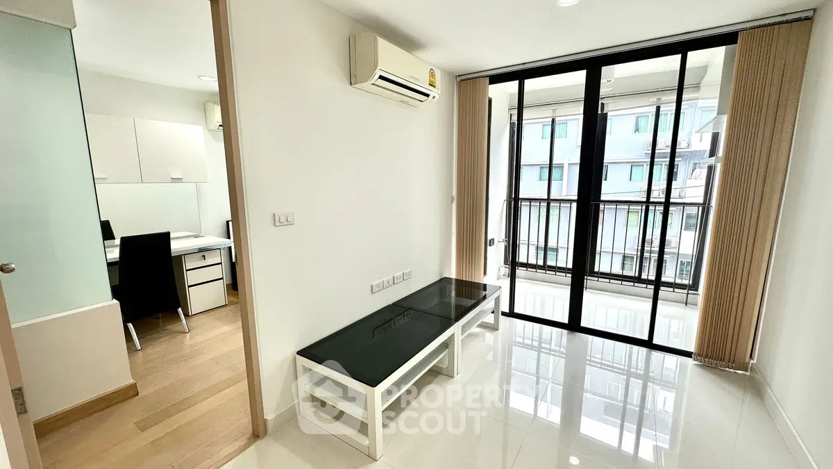 Modern apartment interior with glass table and balcony view