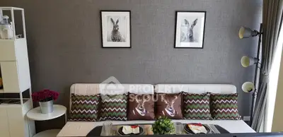 Stylish living room with modern decor and cozy seating area, perfect for relaxation and entertaining.