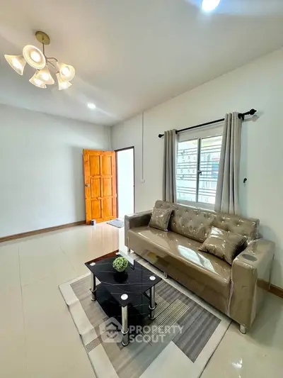 Bright living room with modern sofa and stylish lighting in a cozy apartment.