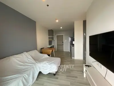 Modern living room with sleek flooring and minimalistic furniture in a stylish apartment.