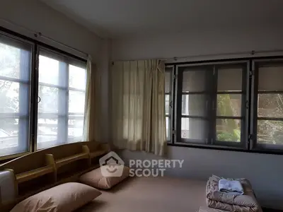Cozy bedroom with large windows and natural light