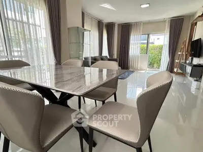 Spacious modern living room with elegant dining area and large windows