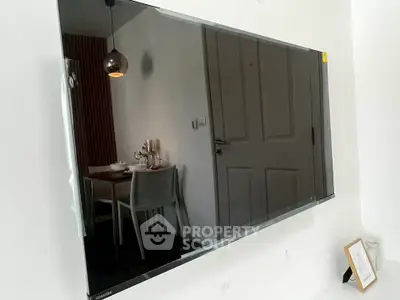 Modern dining area with sleek wall-mounted TV and elegant decor
