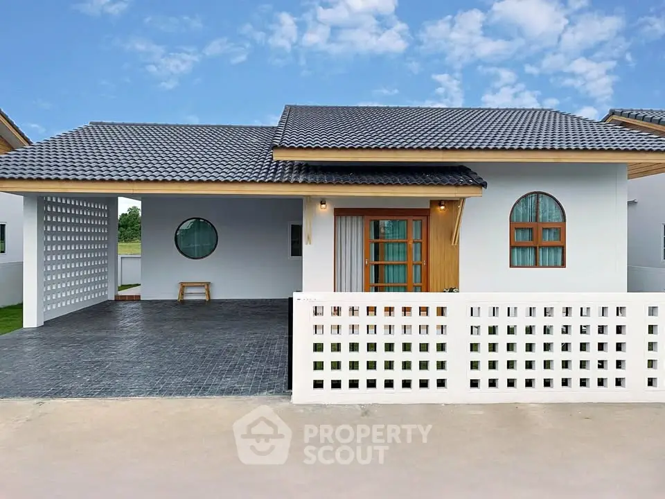 Charming modern house with unique architectural design and spacious driveway.