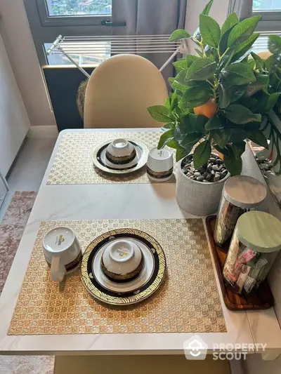 Stylish dining area with elegant table setting and lush plant decor