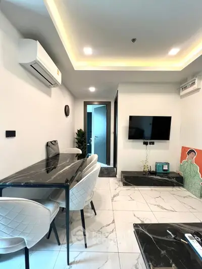 Modern living room with sleek furniture and wall-mounted TV in a stylish apartment.