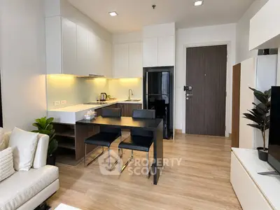 Modern open-layout kitchen with sleek design and dining area in a stylish apartment.