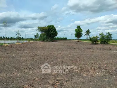Expansive land plot with lush greenery and clear skies, perfect for development opportunities.