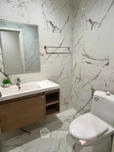 Modern bathroom with marble tiles and sleek fixtures
